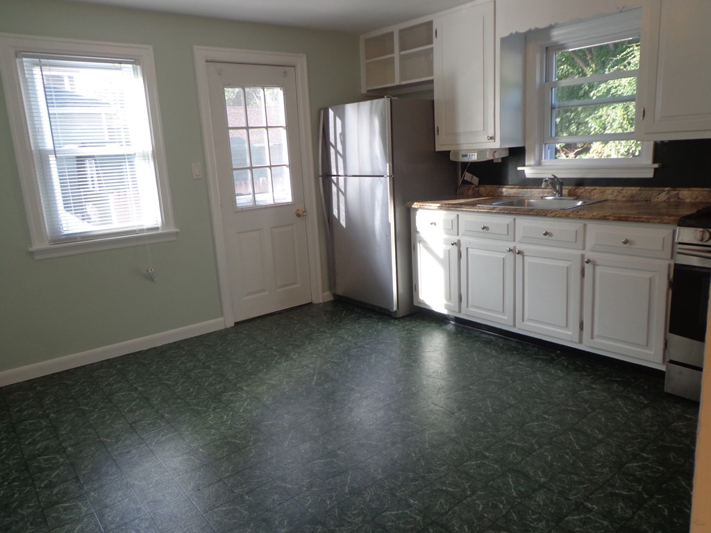 33 Strong Street Springfield, MA 01104 - Photo 4 of 19 a kitchen with stainless steel appliances a refrigerator sink and window