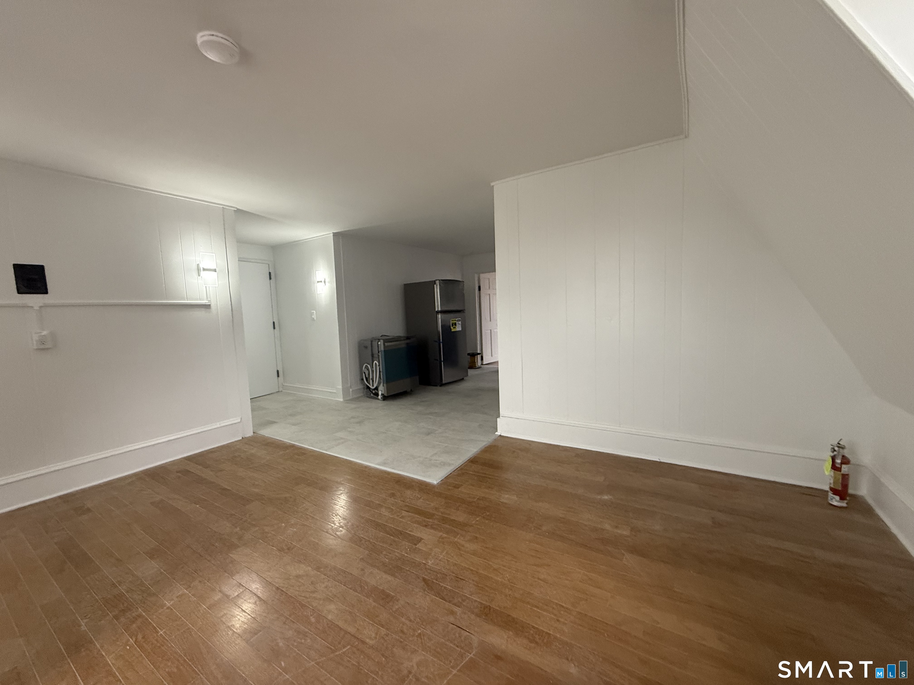 40 Franklin Street New London, CT 06320 - Photo 3 of 9 a view of an empty room with wooden floor and a window