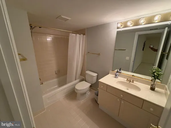 a bathroom with a double vanity sink toilet and shower