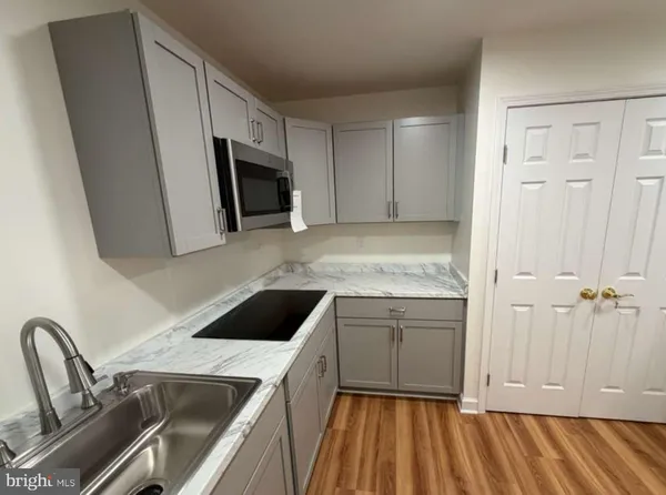 a kitchen with a sink and a microwave