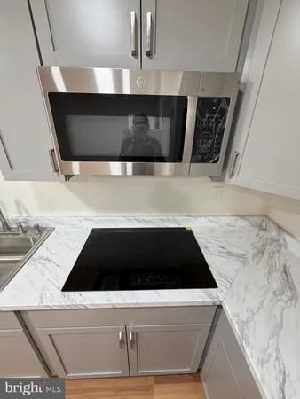 a kitchen with a sink and a stove top oven