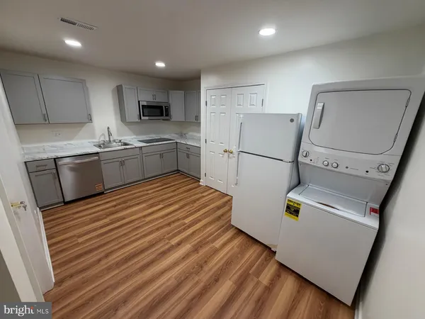 a kitchen with stainless steel appliances a refrigerator sink and microwave