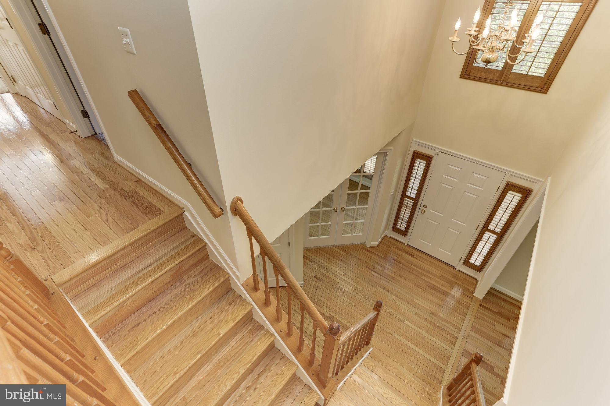 9514 Ridgeview Drive Columbia, MD 21046 - Photo 6 of 60 Dramatic 2 story foyer with hardwood stairs