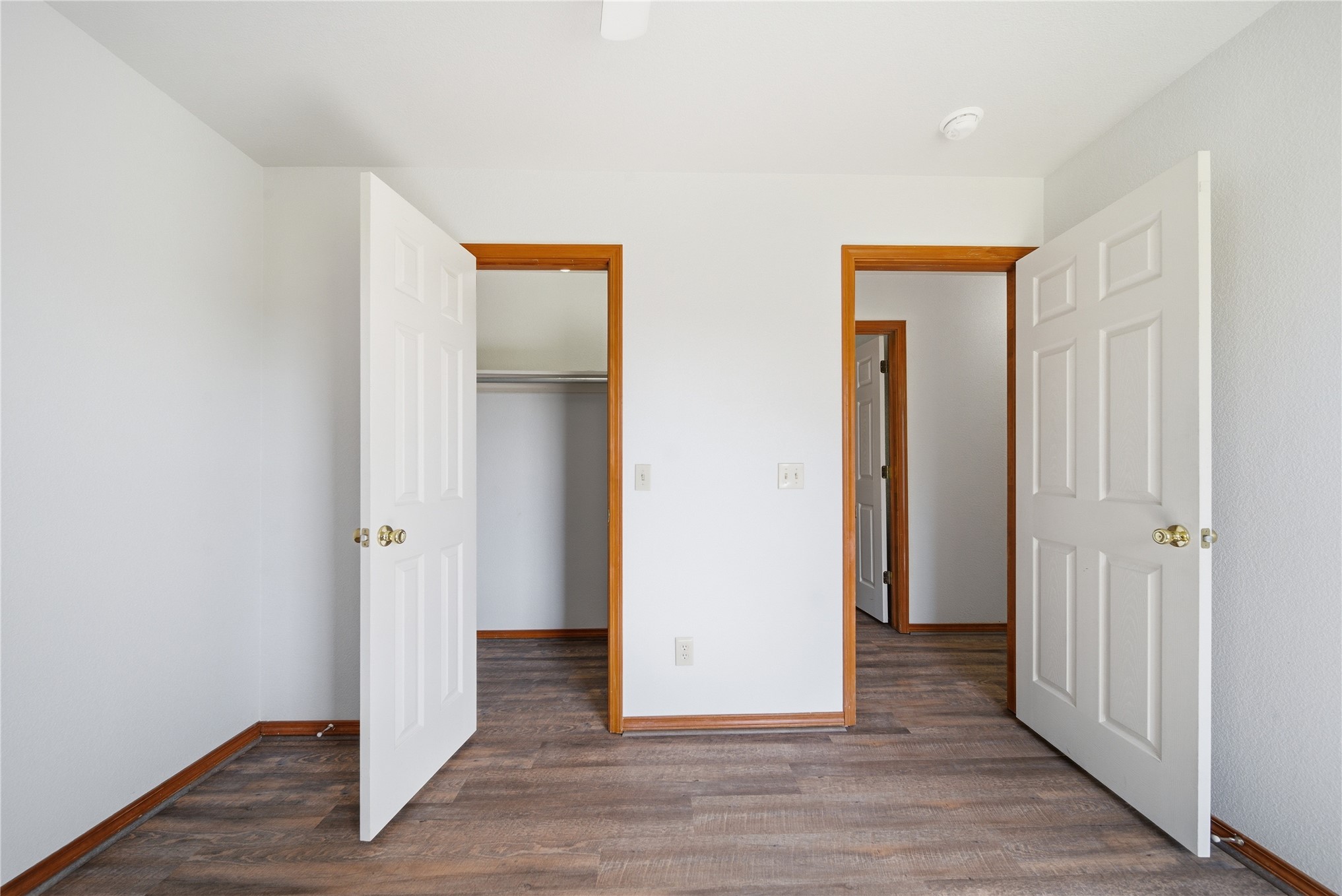 511 Cemetery Road Oktaha, OK 74450 - Photo 23 of 28 Wood-finish flooring, white paneled doors with brass hardware, and light-toned walls