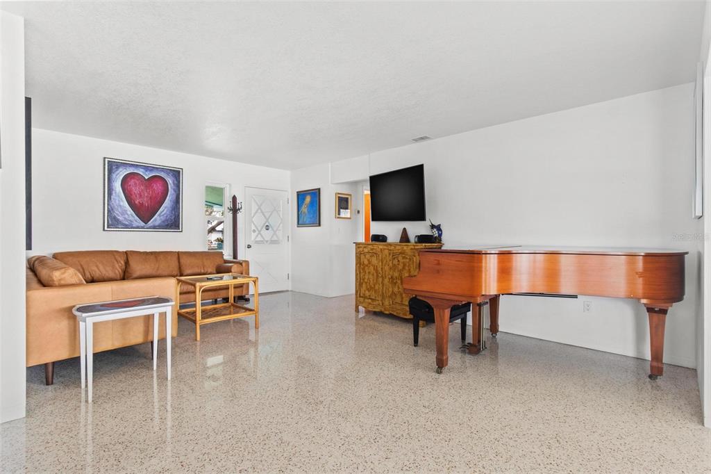 525 Lillian Drive Madeira Beach, FL 33708 - Photo 15 of 29 a living room with furniture and a flat screen tv