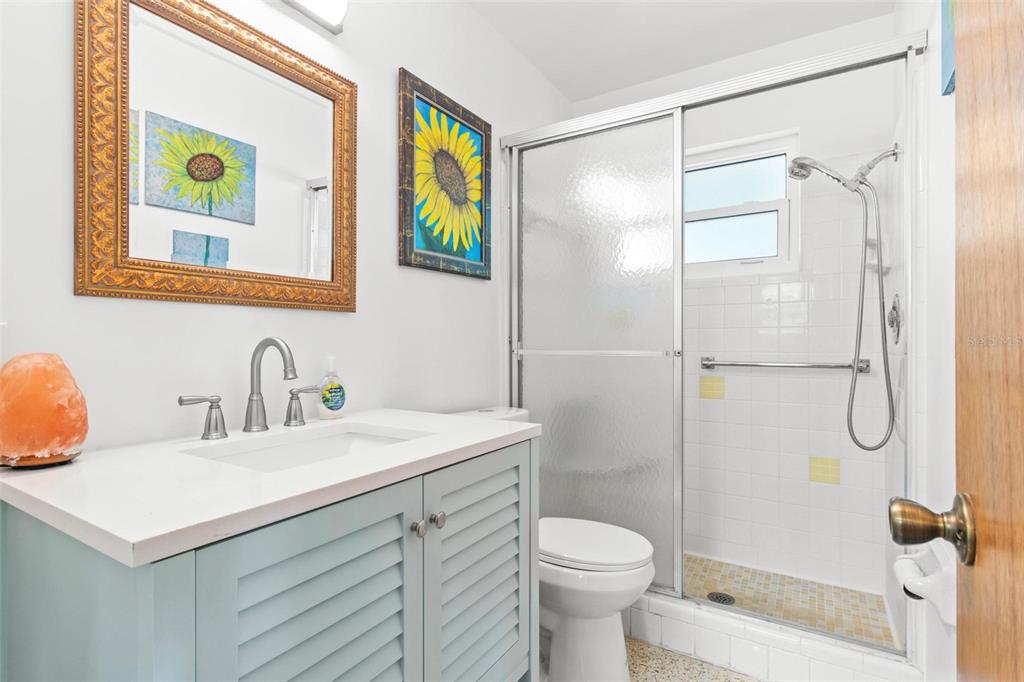 525 Lillian Drive Madeira Beach, FL 33708 - Photo 18 of 29 a bathroom with a sink mirror vanity and toilet