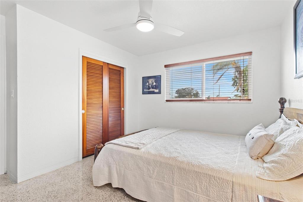 525 Lillian Drive Madeira Beach, FL 33708 - Photo 20 of 29 a bedroom with a bed and window