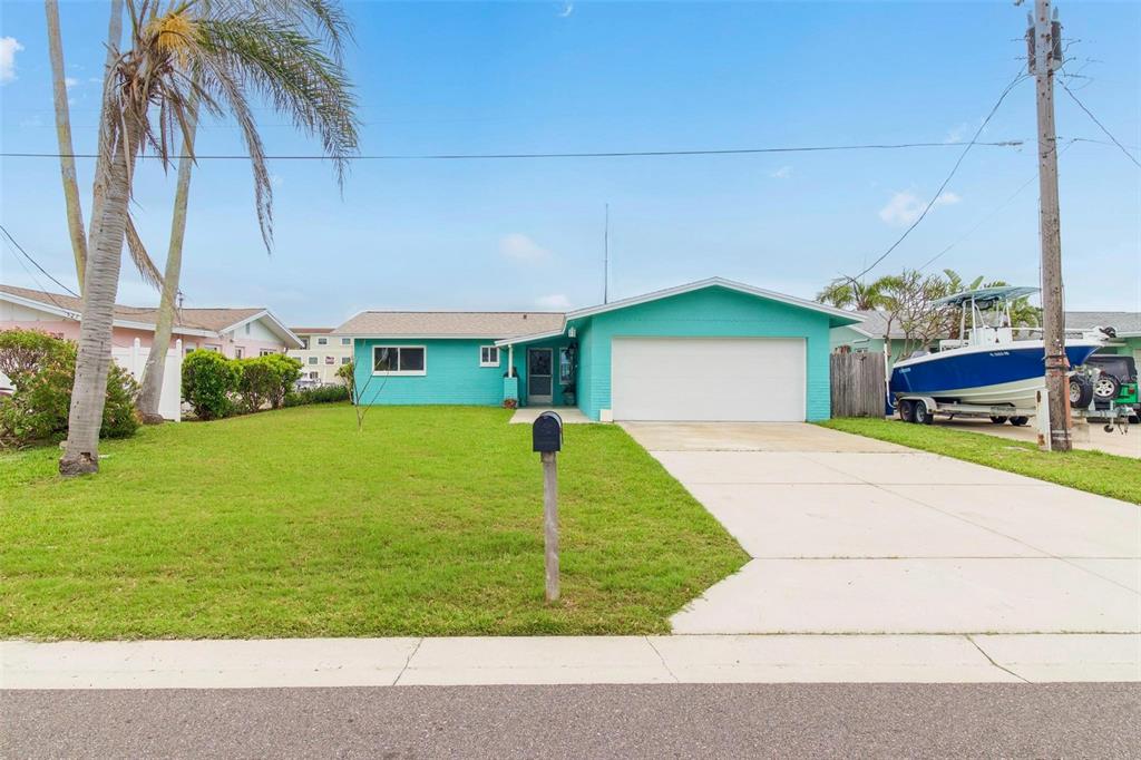 525 Lillian Drive Madeira Beach, FL 33708 - Photo 26 of 29 a front view of a house with a yard
