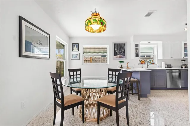 a view of a dining room with furniture and a chandelier