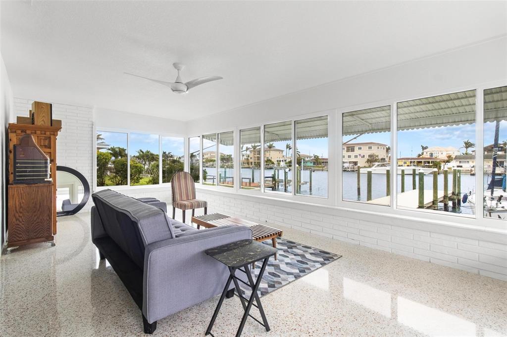 525 Lillian Drive Madeira Beach, FL 33708 - Photo 5 of 29 a living room with furniture and a floor to ceiling window