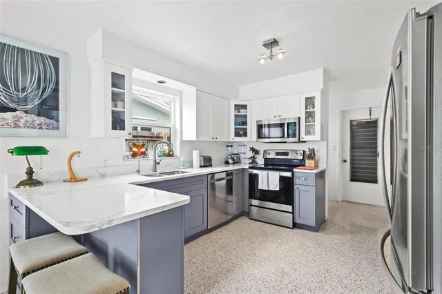 a kitchen with a sink stove and refrigerator