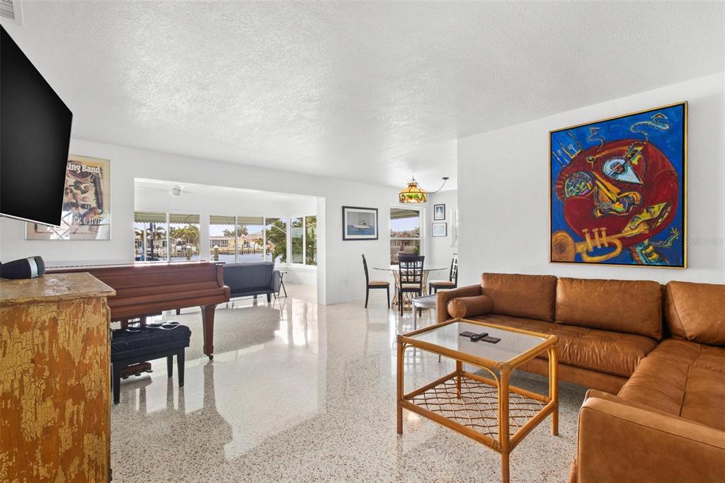 525 Lillian Drive Madeira Beach, FL 33708 - Photo 6 of 29 a living room with furniture a flat screen tv and kitchen view