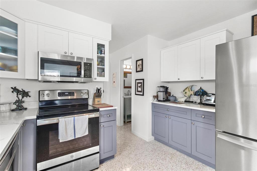 525 Lillian Drive Madeira Beach, FL 33708 - Photo 8 of 29 a kitchen with cabinets stainless steel appliances and a counter space