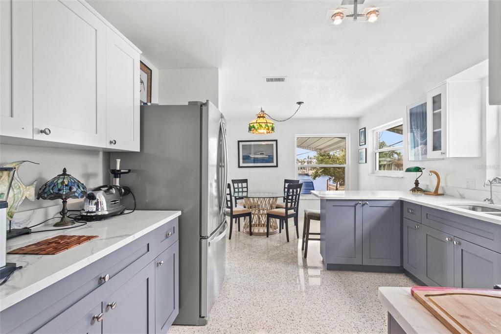 525 Lillian Drive Madeira Beach, FL 33708 - Photo 9 of 29 a kitchen with cabinets a sink and appliances