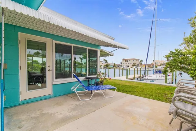 a view of a house with backyard porch and sitting area