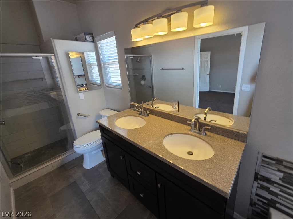 2275 Ramsgate Drive Henderson, NV 89074 - Photo 60 of 84 Double vanities and a tiled shower create a functional, modern bath.