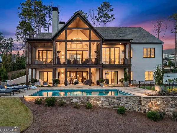 a front view of a house with porch yard and swimming pool