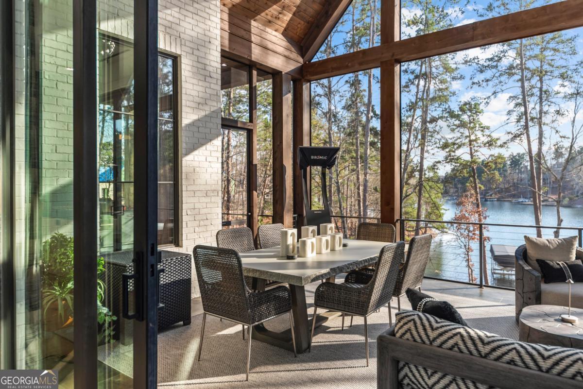 1131 Neary Ridge Greensboro, GA 30642 - Photo 24 of 72 a view of a dining room with furniture large windows and wooden floor