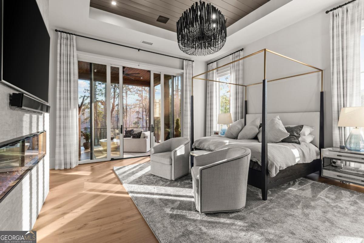 1131 Neary Ridge Greensboro, GA 30642 - Photo 28 of 72 a living room with furniture a large window and a chandelier