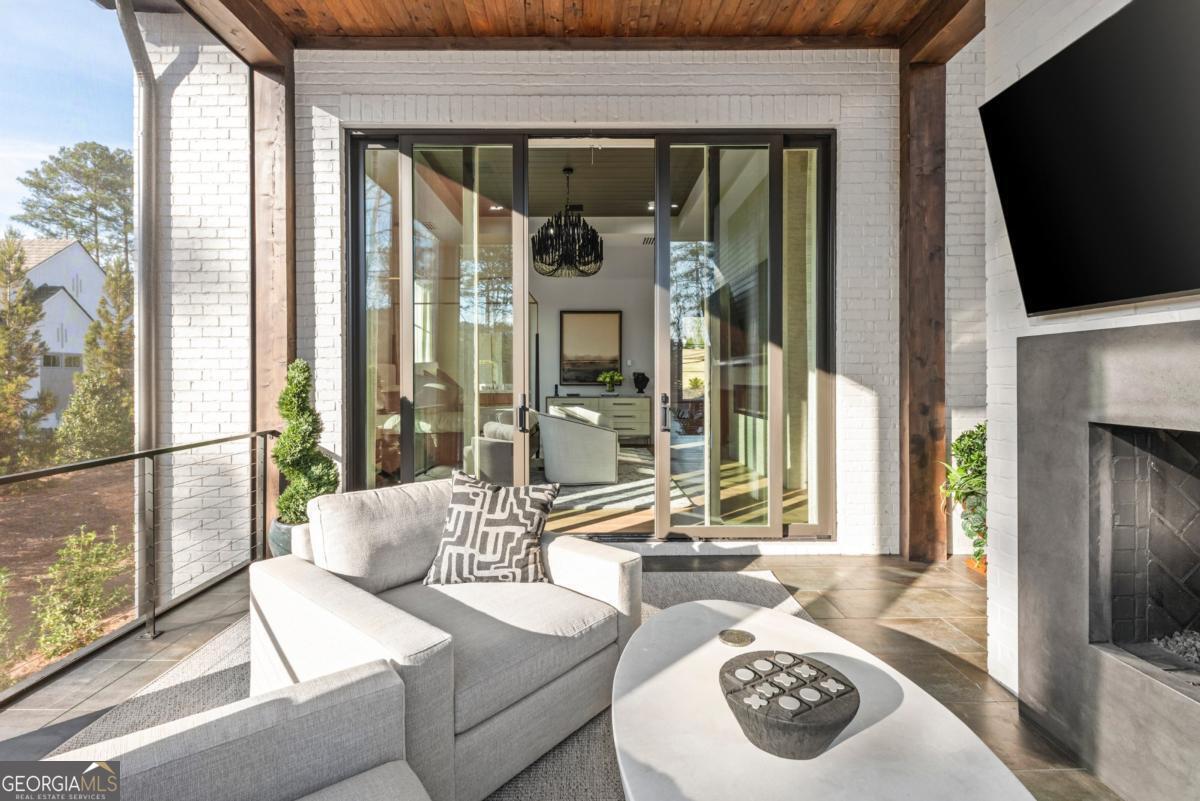 1131 Neary Ridge Greensboro, GA 30642 - Photo 36 of 72 a living room with furniture and a flat screen tv