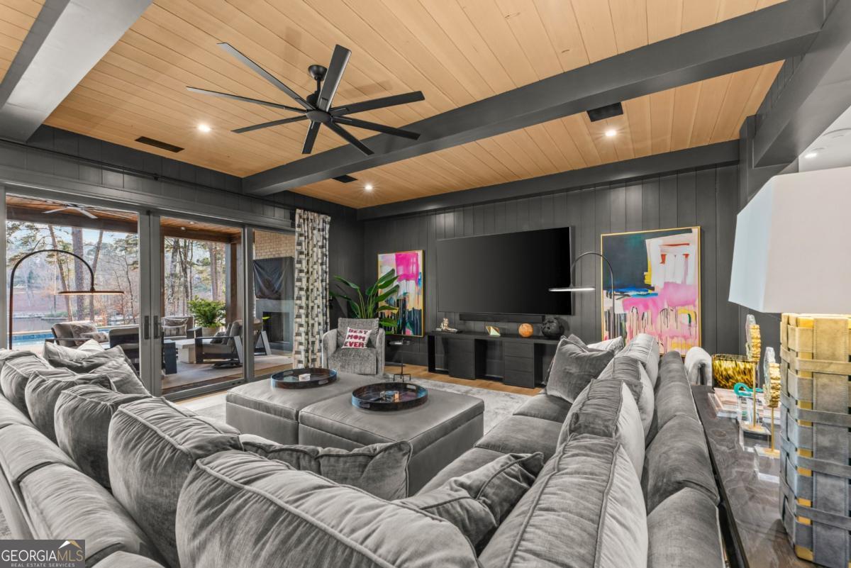 1131 Neary Ridge Greensboro, GA 30642 - Photo 47 of 72 a living room with furniture a flat screen tv and a large window
