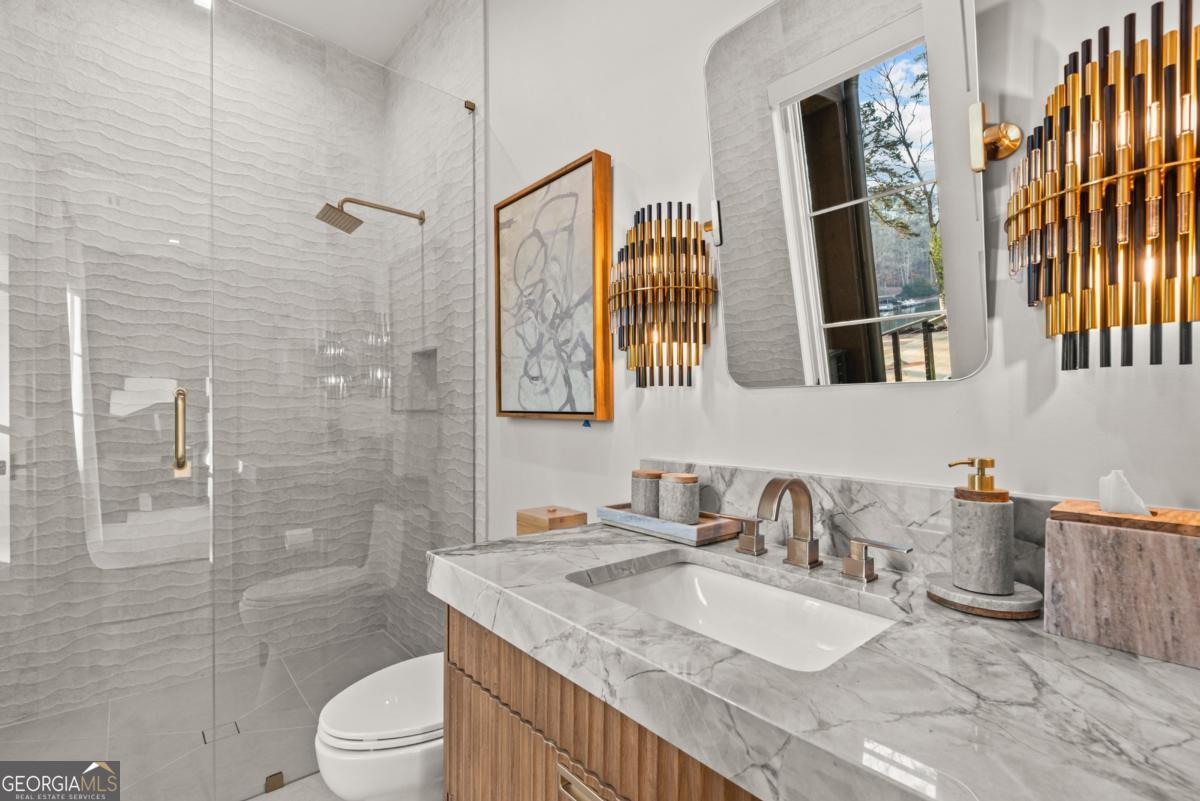 1131 Neary Ridge Greensboro, GA 30642 - Photo 52 of 72 a bathroom with a granite countertop sink toilet and shower