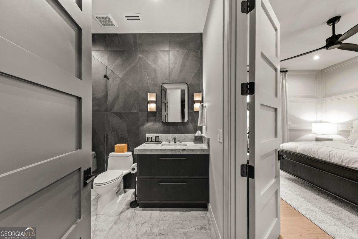 1131 Neary Ridge Greensboro, GA 30642 - Photo 53 of 72 a en suite bathroom with a sink and a mirror