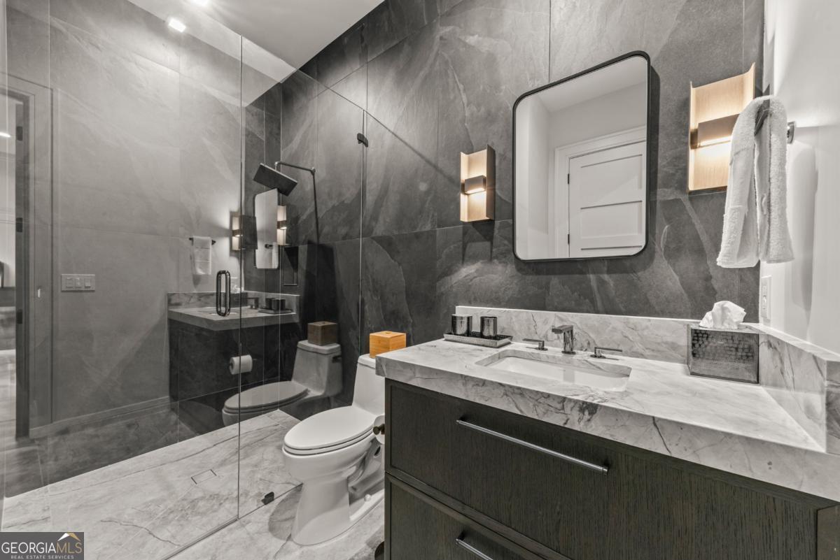 1131 Neary Ridge Greensboro, GA 30642 - Photo 55 of 72 a bathroom with a toilet sink and mirror