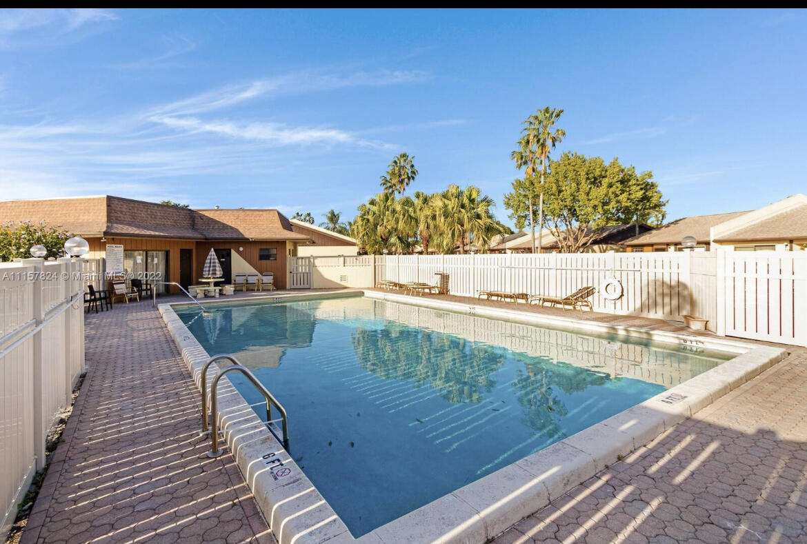 595 Banks Road Margate, FL 33063 - Photo 4 of 35 a view of a swimming pool with a lounge chairs
