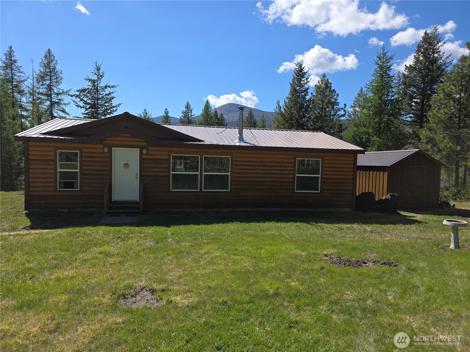 393 Summer Road Tonasket, WA 98855 - Photo 14 of 37 a front view of a house with a garden
