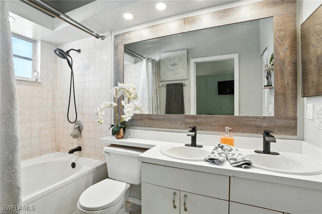 5242 17th Place Southwest Naples, FL 34116 - Photo 12 of 19 a bathroom with a sink a toilet and shower