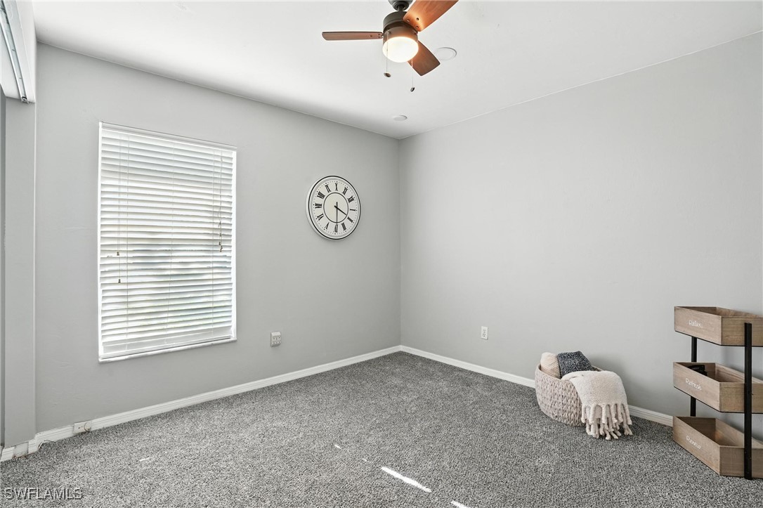 5242 17th Place Southwest Naples, FL 34116 - Photo 14 of 19 a room with a window and a fan