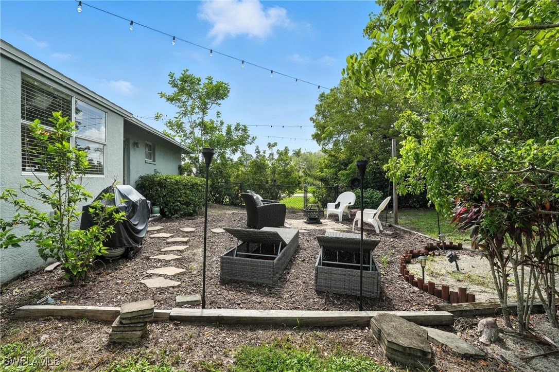 5242 17th Place Southwest Naples, FL 34116 - Photo 16 of 19 a view of a house with backyard sitting area and garden