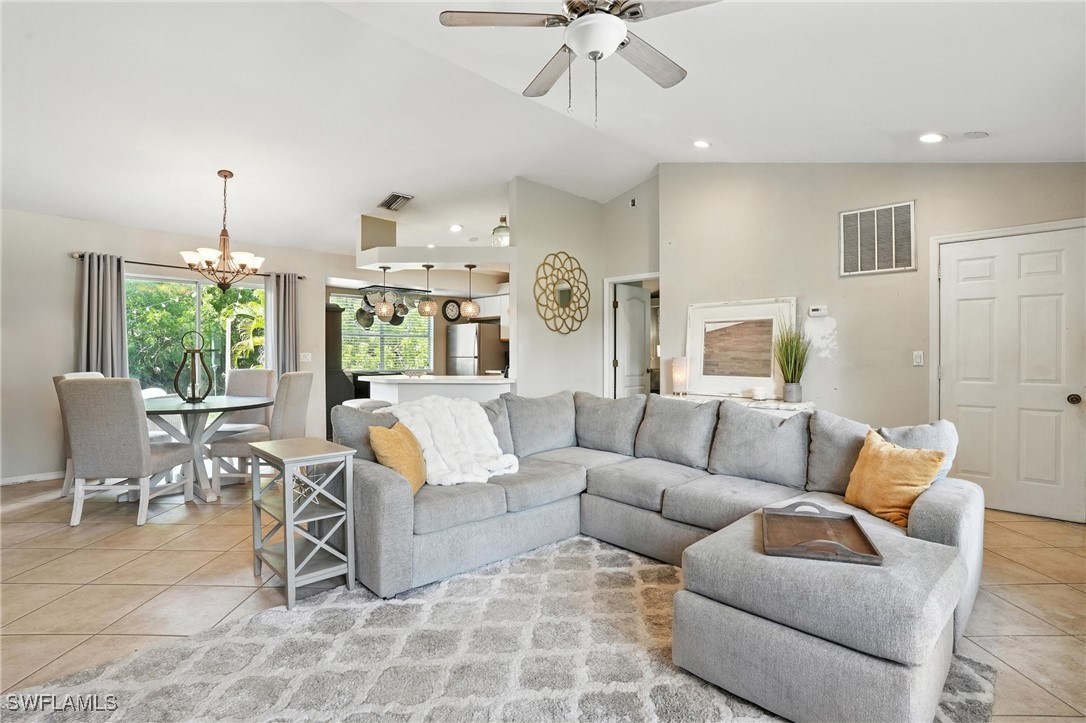 5242 17th Place Southwest Naples, FL 34116 - Photo 2 of 19 a living room with furniture and a chandelier