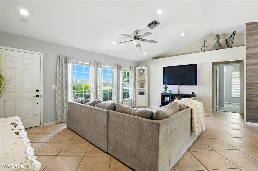 5242 17th Place Southwest Naples, FL 34116 - Photo 5 of 19 a living room with furniture and a flat screen tv