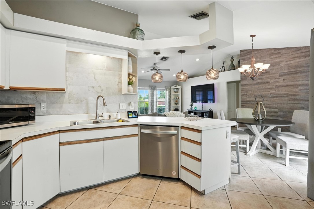5242 17th Place Southwest Naples, FL 34116 - Photo 9 of 19 a kitchen with cabinets and chairs