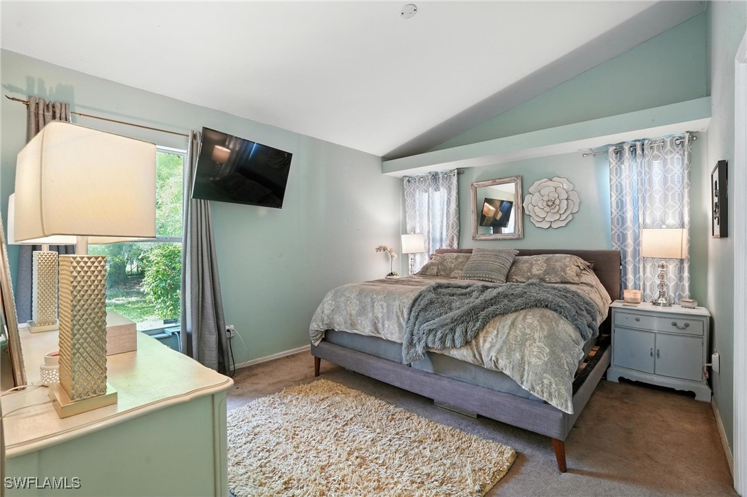 5242 17th Place Southwest Naples, FL 34116 - Photo 10 of 19 a bedroom with a bed and a flat tv screen next to a window
