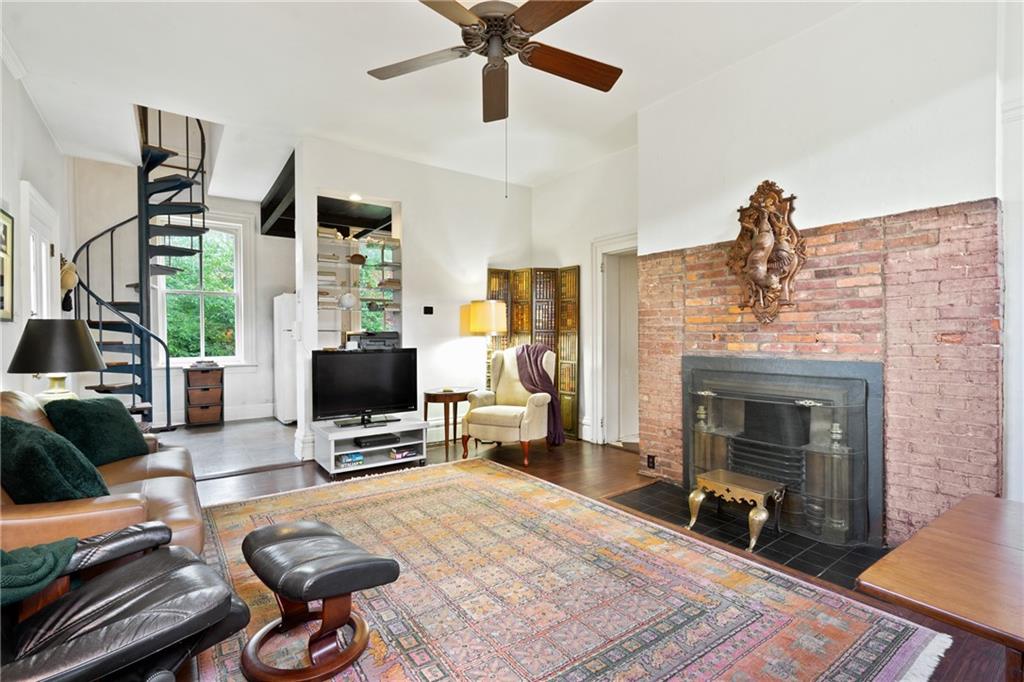 4841 Ellsworth Avenue Pittsburgh, PA 15213 - Photo 13 of 25 a living room with furniture a fireplace and a flat screen tv
