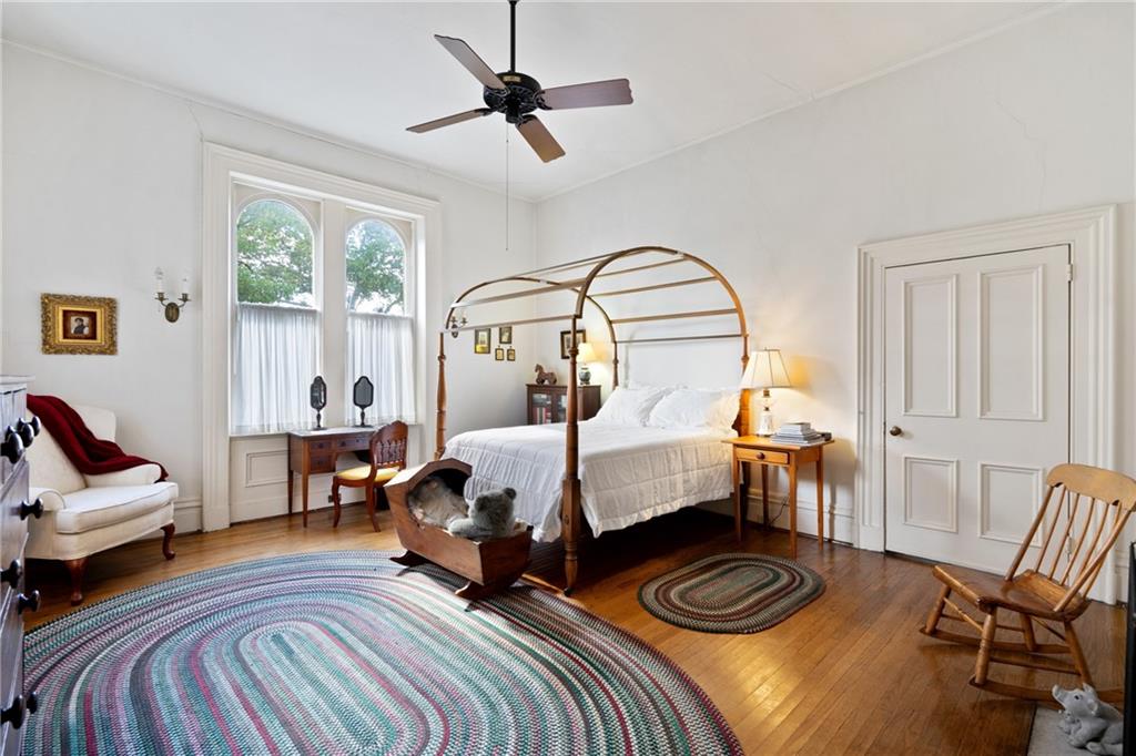 4841 Ellsworth Avenue Pittsburgh, PA 15213 - Photo 20 of 25 a bedroom with bed and a chandelier