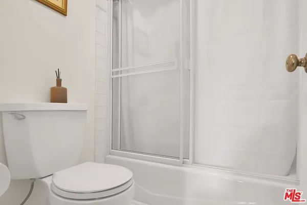 a bathroom with a toilet and a shower