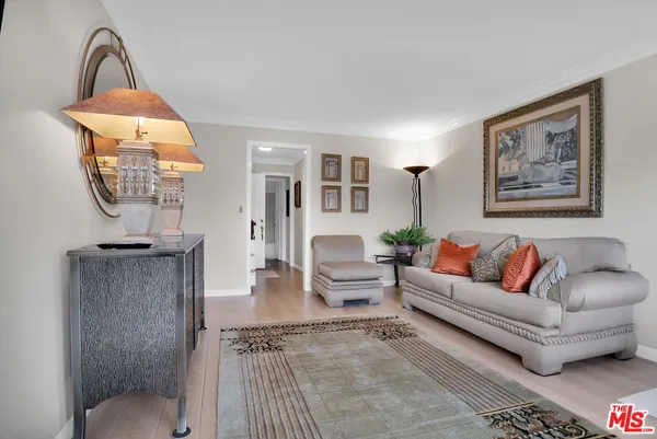 a living room with furniture and a painting