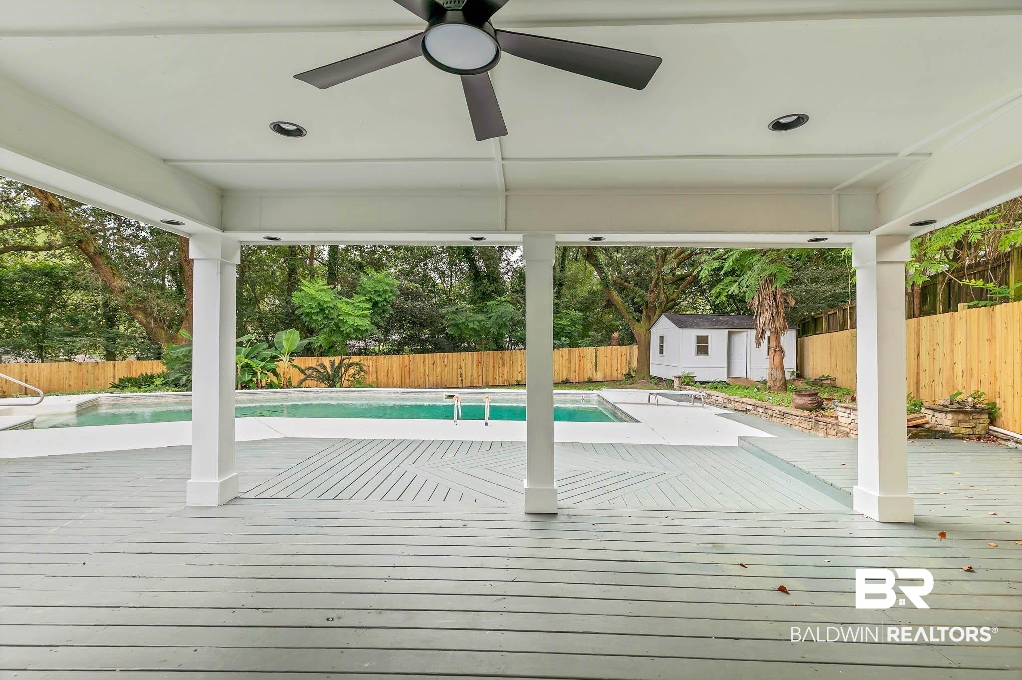 4705 Sherry Court Mobile, AL 36693 - Photo 71 of 100 View of pool with a fenced backyard, a storage shed, a ceiling fan, and a wooden deck