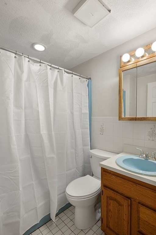 59 Proctor Circle Peabody, MA 01960 - Photo 14 of 32 a bathroom with a sink a toilet and a mirror