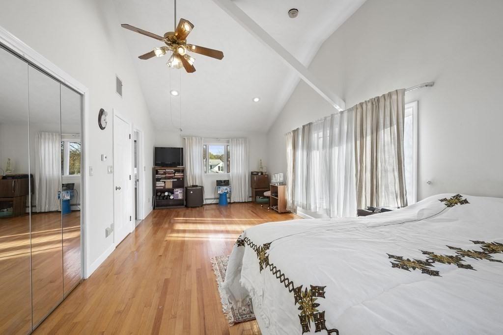 59 Proctor Circle Peabody, MA 01960 - Photo 16 of 32 a large bedroom with wooden floor and a ceiling fan