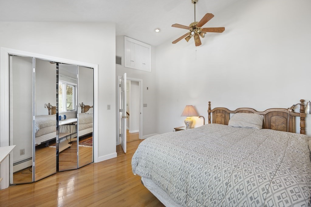 59 Proctor Circle Peabody, MA 01960 - Photo 19 of 32 a bedroom with bed and a chandelier
