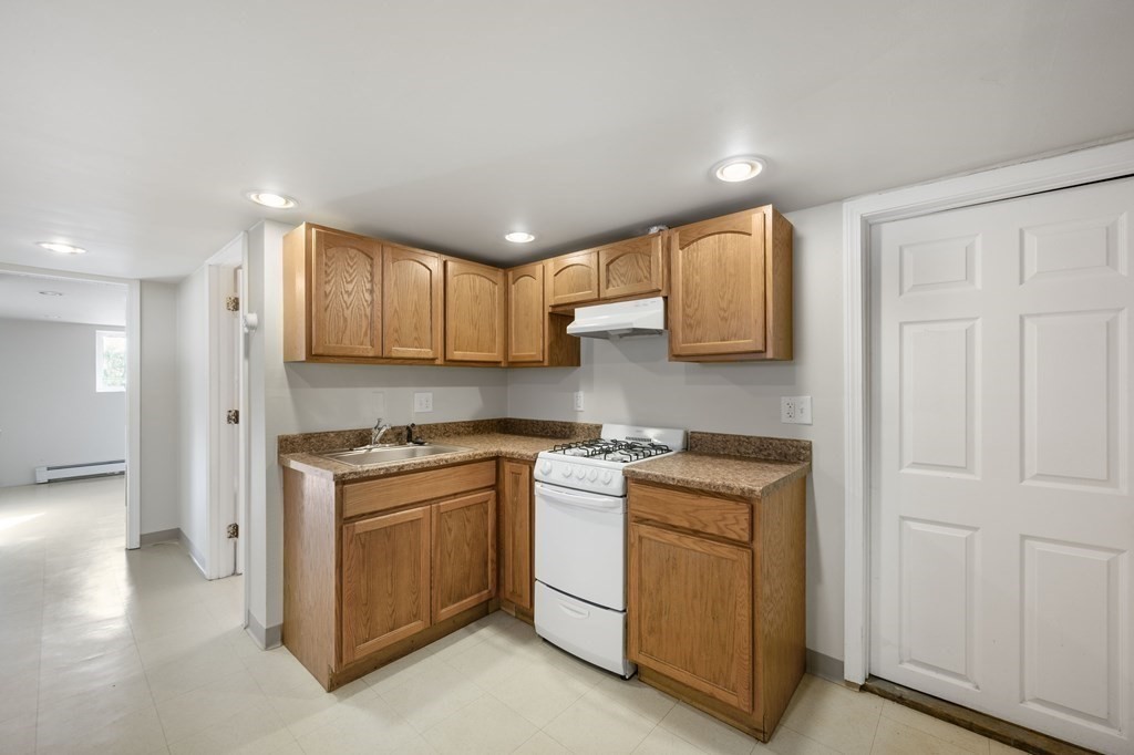 59 Proctor Circle Peabody, MA 01960 - Photo 24 of 32 a kitchen with a stove top oven sink and cabinets