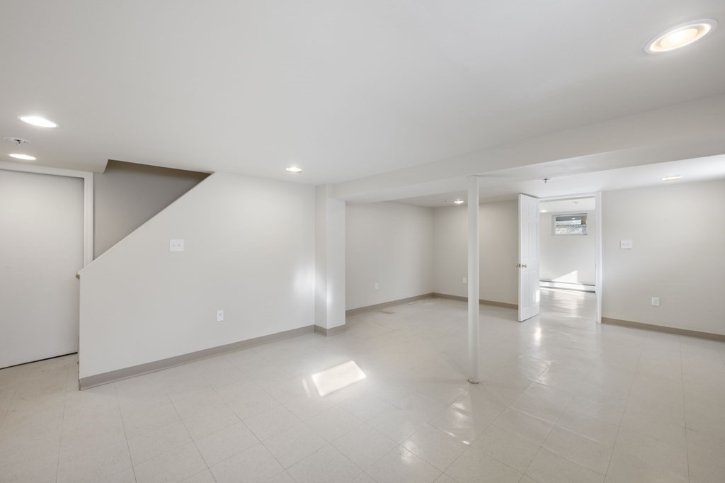 59 Proctor Circle Peabody, MA 01960 - Photo 26 of 32 a view of an empty room with wooden floor and a window