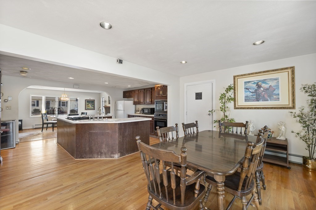 59 Proctor Circle Peabody, MA 01960 - Photo 7 of 32 a dining hall with stainless steel appliances granite countertop a dining table and chairs with wooden floor