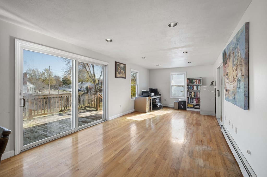 59 Proctor Circle Peabody, MA 01960 - Photo 10 of 32 a large living room with wooden floor and large windows