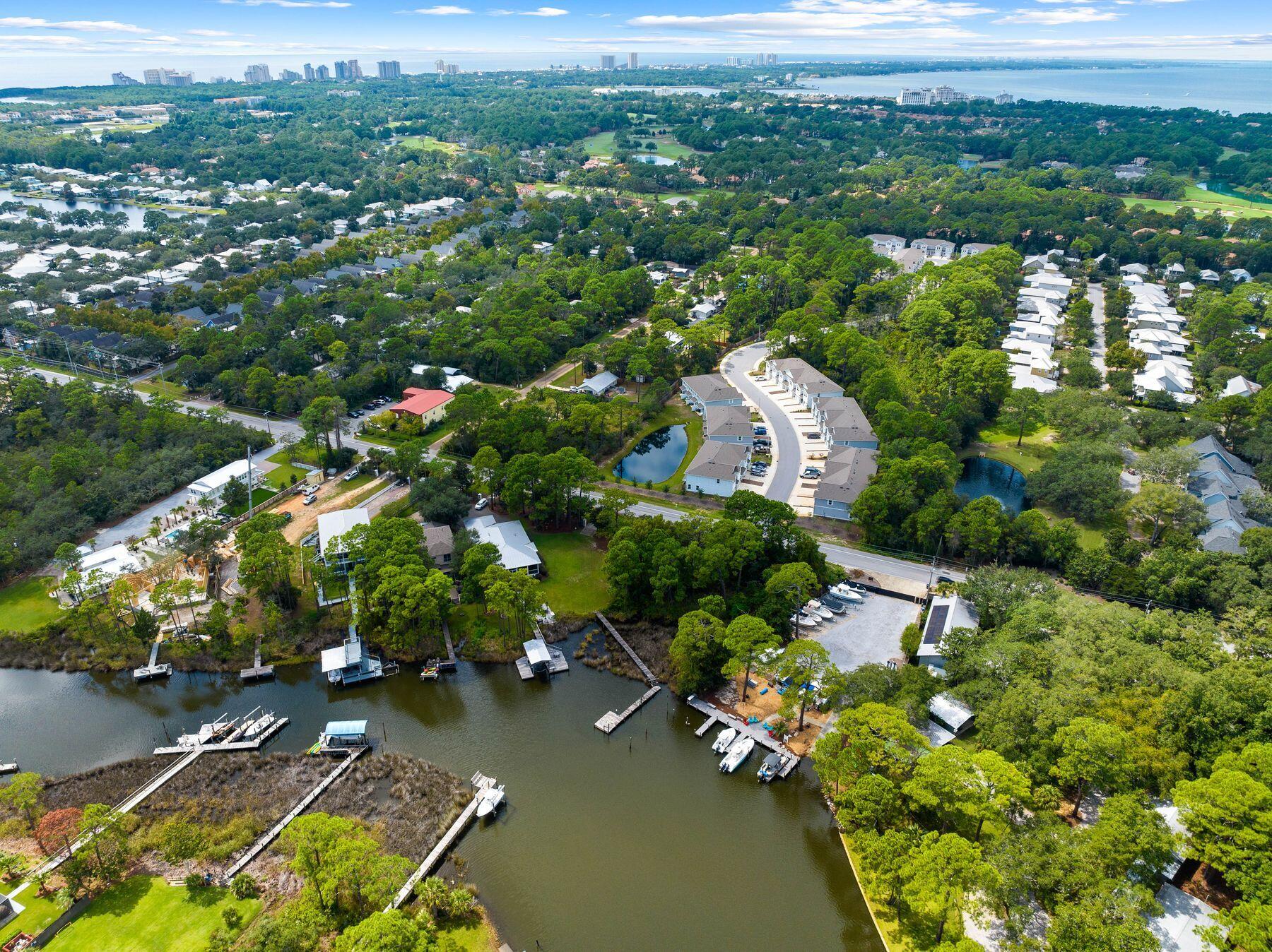 1196 Mack Bayou Road Santa Rosa Beach, FL 32459 - Photo 2 of 19 an aerial view of a house with a yard swimming pool outdoor seating and lake view
